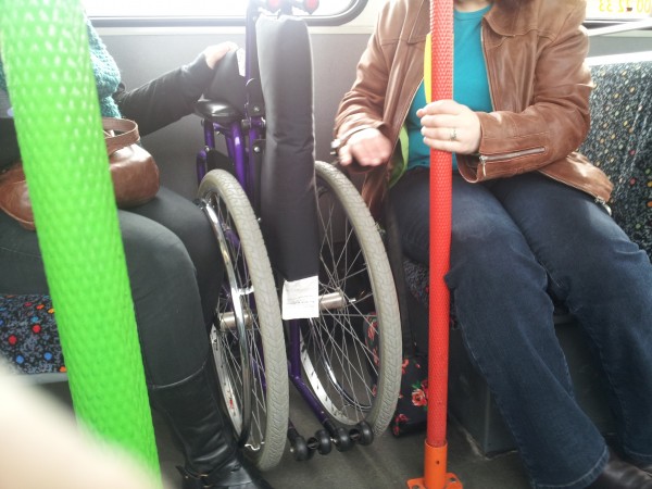 Folded wheelchair on a bus Folded wheelchair on a bus